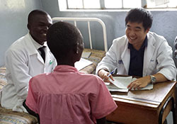 James Yuan visits with patients in the diabetes ward at Soroti Hospital.