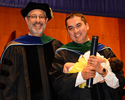 Jesus with Fabiola, at graduation, after being hooded by Dr. Myles Akabas