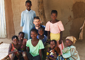 Mr. O’Laughlin with local children in the Mali community where he worked as a Peace Corps volunteer