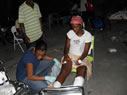 Dr. Mahalia Desruisseaux finishes bandaging a patient's wounds