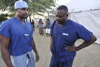 At Love-a-Child Field Hospital and Refugee Camp in Fond Parisien, Haiti, Dr. Stan Frencher (class of 2006) with Dr. Bill Releford, a podiatric surgeon from Inglewood and founder of the Diabetic Amputation Prevention Foundation, who is a wound care specialist. Photo by Chet Gordon
