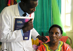 A Uganda physician examining a 60-year-old Ugandan woman who will get an artificial leg custom-made by our partner institution in India